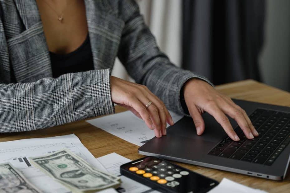 a woman in plaid blazer using her laptop