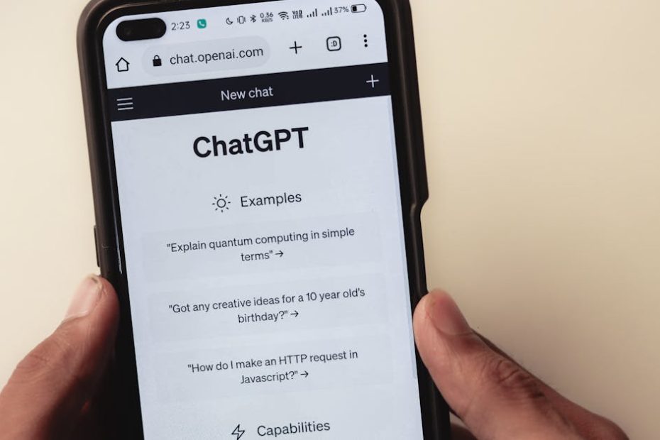 close up of hands holding a smartphone displaying the chatgpt application interface on the screen